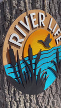Load and play video in Gallery viewer, Cattails River Life Hand Painted Wood Sign Door Hanger Sunset Goose - Dark Background