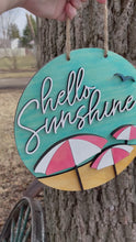 Load and play video in Gallery viewer, Hello Sunshine Beach Round Wood Sign Umbrellas
